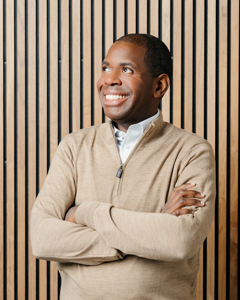 Des Dorsey in a sweater with arms crossed, smiling