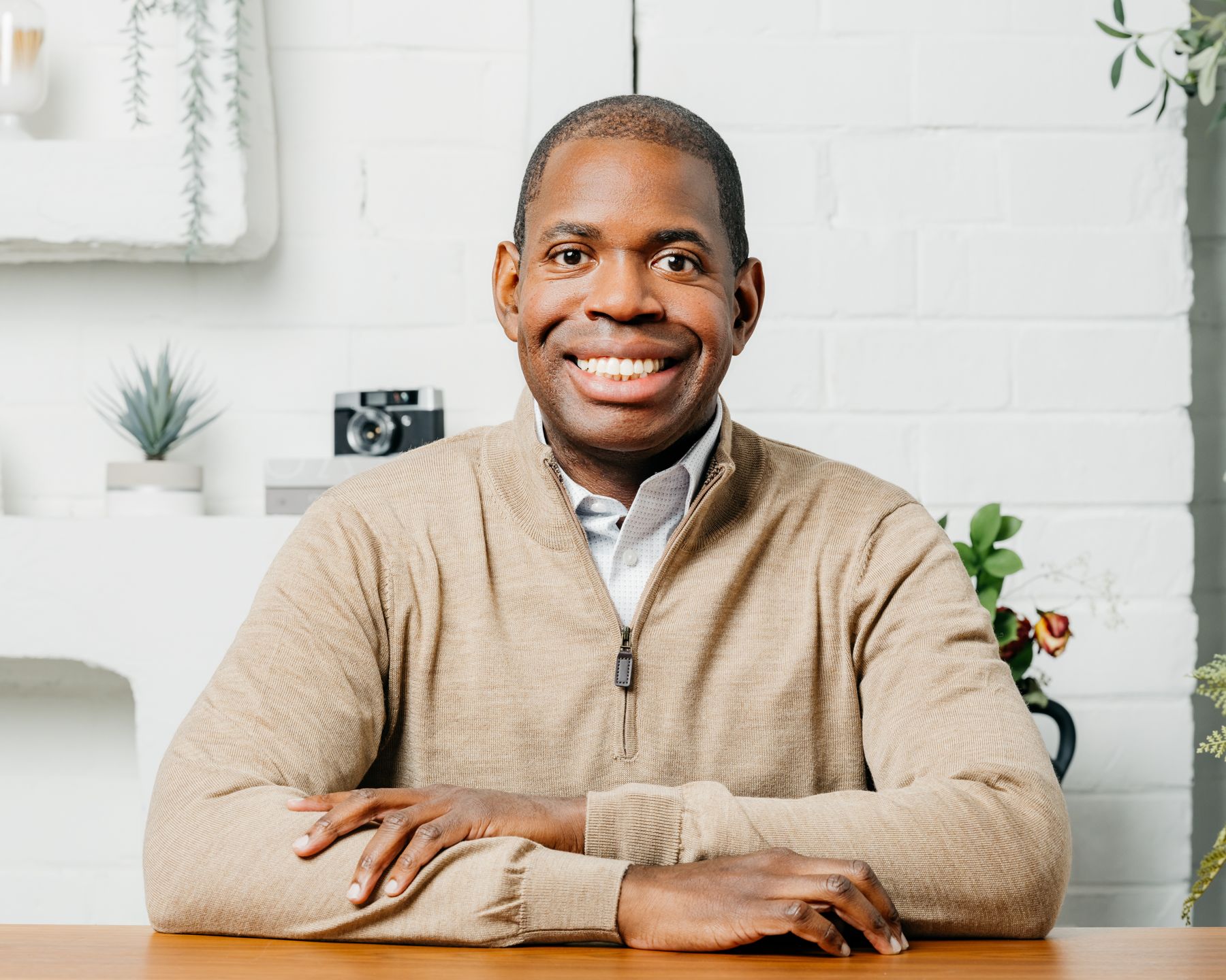 Des Dorsey seated at a table, smiling